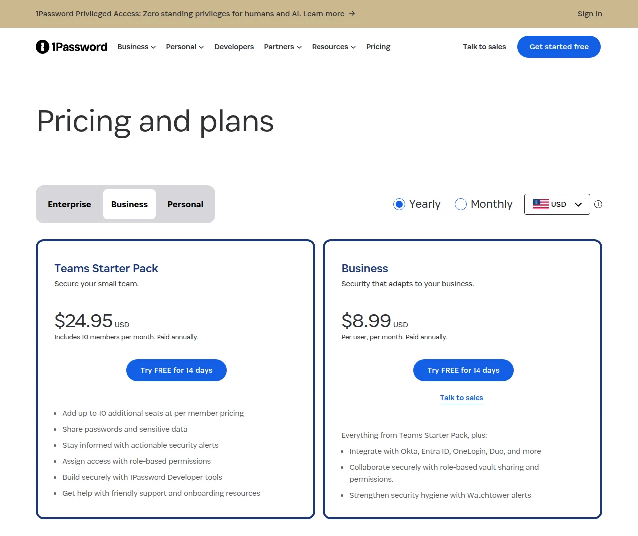 1PasswordのPricing and plansのページ(Business・Yearly・USDの表示)。Teams Starter Packは$24.95 USD(10人分を含む月額、年払い)で、追加の10席を1人ごとの料金で足せること、パスワードの共有などが並ぶ。Businessは$8.99 USD(1人あたり月額、年払い)で、Okta・Entra ID・OneLogin・Duoなどとの連携、役割に応じた保管庫の共有、Watchtowerの警告などが並ぶ。どちらも14日間の無料体験のボタンがある